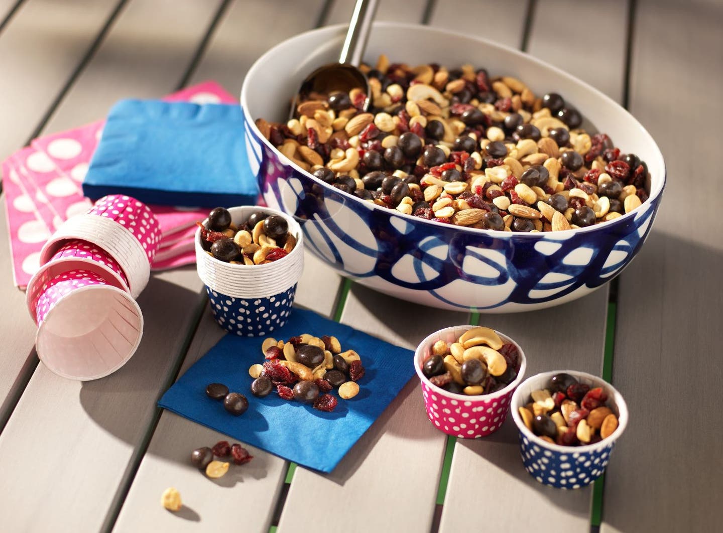 large bowl and a few small cups filled with trail mix