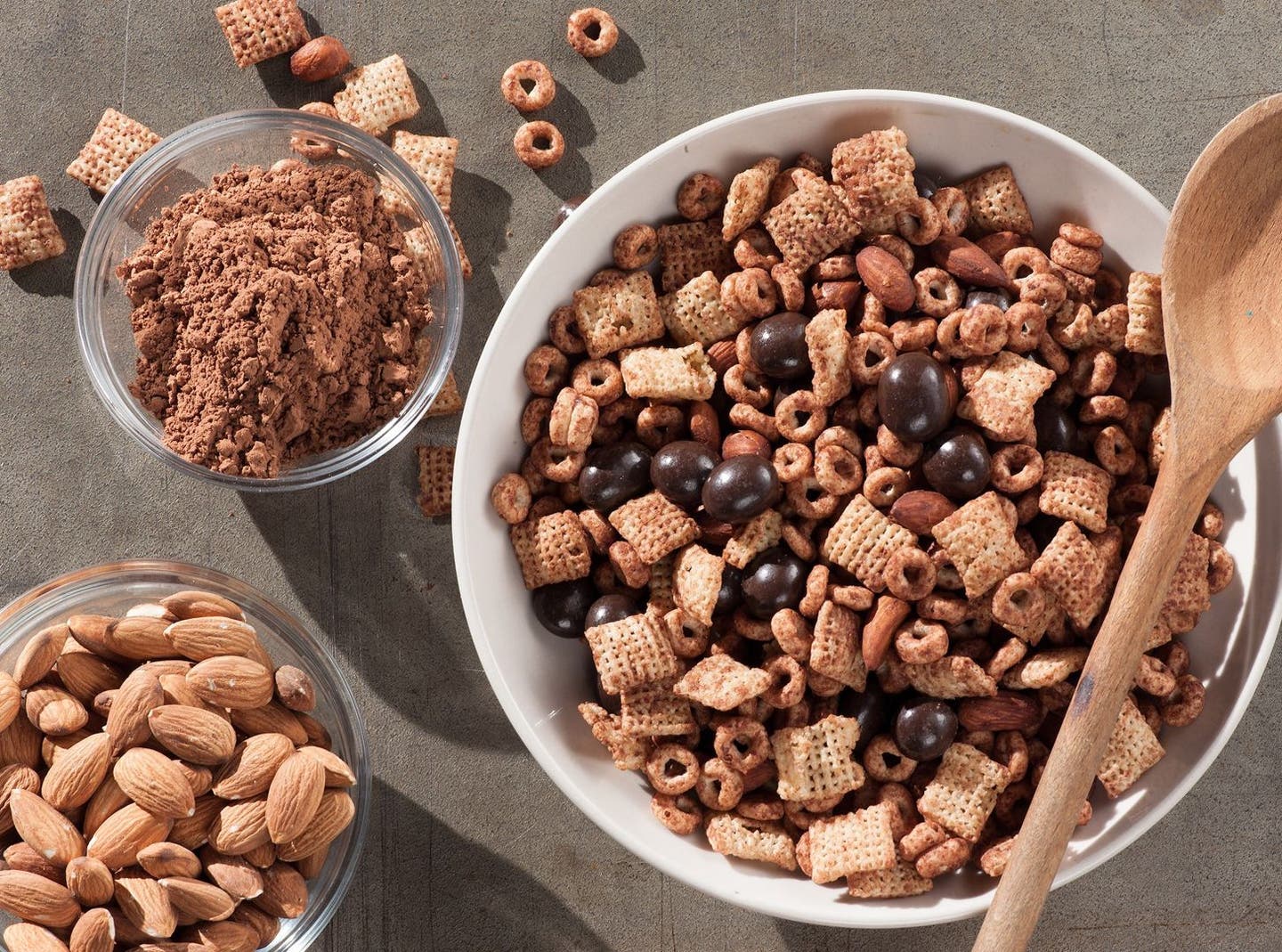 a big bowl of brookside snack mix with cups of ingredients beside it