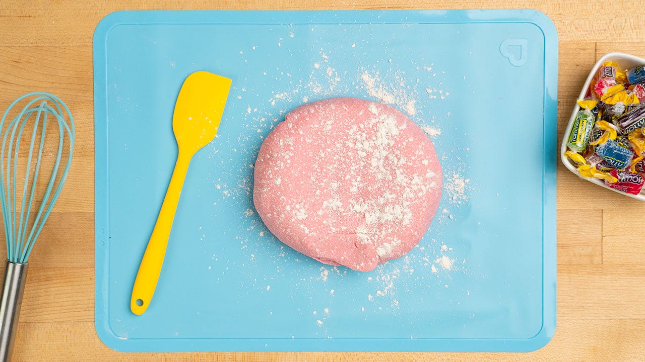 dough on cutting board with more flour sprinkled on top