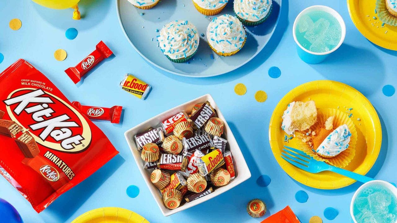 table filled with assorted party decorations and sweets