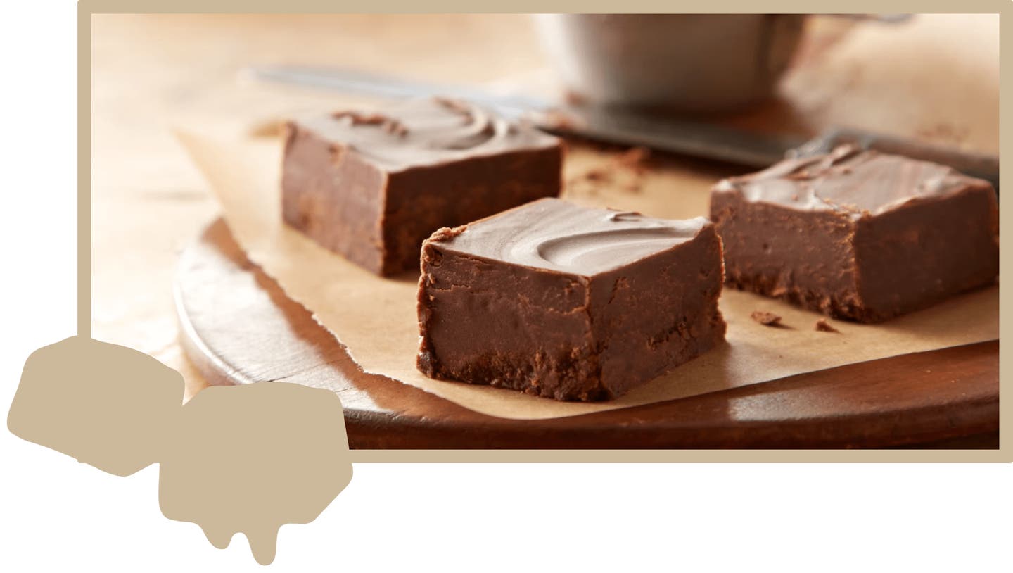 Fudge cut into squares on top of wooden cutting board